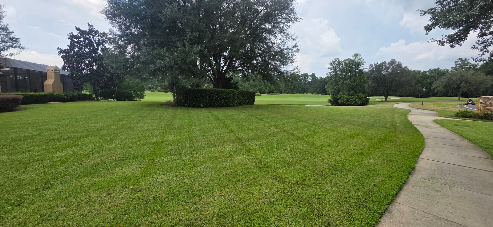 Freshly maintained lawn beside a golf course